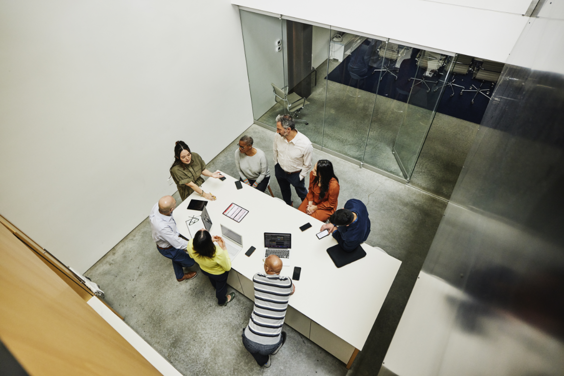 Group of people sitting around a table participating in a collaborative workshop session.